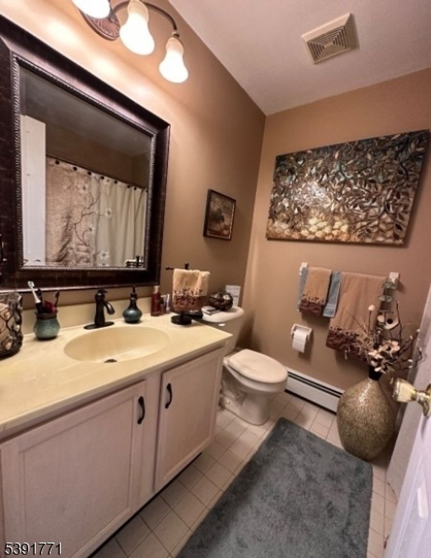 Don't miss this AWESOME rental to call home.  Move in with it furnished, partially furnished or empty bringing all your own furniture.  The location can't be beat as you are nearby to the bus stop to NYC, a large variety of local stores, restaurants and a movie theatre.  The unit is set in a private part of the complex overlooking the pristine landscaping. In addition, you have a large deck and a patio along with a 2 car garage.  Inside, there are hardwood floors, overhead lighting, hot water baseboard heat, central air, lots of closets, including a very large walk-in. The kitchen and baths are updated and all the appliances are new.  The lower level offers additional space for a large great room, workout or office.  The complex has so much to offer including a pool.  Available for Jan. 15, 2026