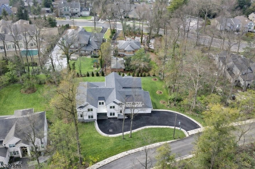Estimated taxes are approximately $61,600 per assessor based on plans; subject to change and verification. Exceptional new construction minutes from NYC offering approximately 9,600 square feet across three finished levels. Designed for both everyday living and luxury, this home features cathedral ceilings, exposed beams, custom millwork, and wide plank white oak floors. The main level offers a light-filled open layout anchored by a dramatic great room with a fireplace and oversized windows. The kosher kitchen is truly a standout, featuring dual quartz islands, double sinks, double ovens, two integrated refrigerators, and a walk-in pantry. Dining area with wet bar flows to a covered outdoor living space with kitchen, fireplace, and heaters for year-round use. Main level also includes an en suite bedroom, office, and mudroom. The second level features five en suite bedrooms, including a primary suite with vaulted ceilings, a fireplace, a spa bath, a custom closet, and a balcony. Laundry room with a double washer-and-dryer set. The walk-out lower level offers large windows, yard access, an en suite bedroom, recreation areas, and a lounge bar. Generous backyard with room for a pool. Three-car garage with high ceilings and EV charging. Ideally located near top private schools, multiple houses of worship, and NYC access.