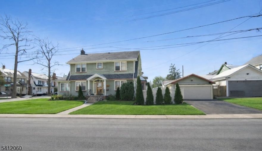 Classic Colonial with gabled roofline featuring 4 brs / 2 bths in sought-after Upper Ivy Hill, Newark. Situated on a quiet dead-end street, this well-maintained home offers approx., 3,570 sq. ft. plus a full basement. A semi-open layout unveils formal Liv/Din rooms that seamlessly connects den/home office highlighted by h/w floors, fireplace, and abundant natural light. The Chef's kitchen boasts solid wood cabinetry and custom built-in open wood shelving offering abundant storage and curated display space. SS-Appliances including a fridge, range oven, and dishwasher. Exposed brick accent wall, sink with open windows and a dedicated butcher block prep area enhance both character and functionality. Level 2 offers 3 brs,  with ample closet space, including an expansive primary bedroom approx.. 12.7 x 23.7 featuring h/w floors, a bay window sitting area, and abundant natural light. The main bath showcases a double-sink vanity with quartz countertops, shaker cabinetry, matte black fixtures, oversized framed mirrors with tiled tub/shower combination. Level three features a huge, secluded 4th br (attic). Basement comes with full bath, laundry room, exercise room additional storage room. Other features of this magnificent home include, privacy fence, attached garage, parking for 3 cars. For those who commute, proximity to NYC buses, trains and close to major highways. Steps away from Ivy Hill Park and the rear entrance of Seton Hall University