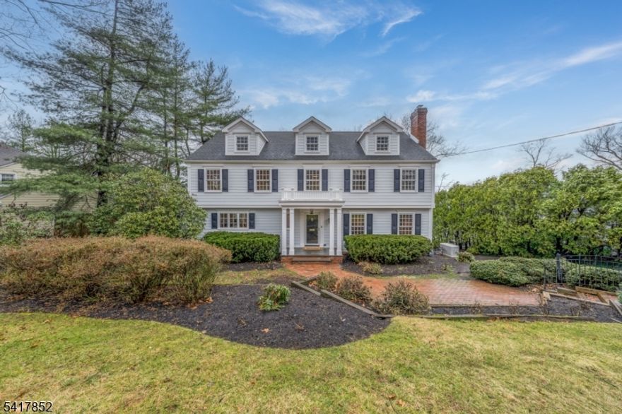 TIMELESS 5-BEDROOM COLONIAL NESTLED IN ONE OF SUMMIT'S MOST COVETED NEIGHBORHOODS. Boasting impeccable curb appeal with a stately portico entry, & beautiful landscaping. Inside, timeless hand-carved millwork and raised-panel wainscoting blend seamlessly with modern amenities, including Wolfe, Sub-Zero, and Miele appliances, plus second-level laundry. Rich hardwood floors extend throughout a thoughtfully designed floorplan perfect for entertaining, w/ grand-scale rooms and effortless access to outdoors. Sophisticated formal Living Room opens to regal Dining Room w/ crystal chandelier, intricate moldings, & glass doors leading to a cedar deck. Gourmet chef's Kitchen stuns w/ imported tile backsplash, Center Island, 2 dishwashers, & more. Bright breakfast area & inviting Family Room offer exceptional custom storage. Handsome home Office features gas fireplace w/ marble surround, flanked by rich cherry bookcases. 2nd level, the peaceful Primary Suite gives abundant storage including 2 double-door closets and Walk-In California closet & luxurious bath with soaking tub, custom vanity, towel warmer, heated floors, and glass-enclosed shower with multiple heads. Four additional sun-filled bedrooms share a beautifully appointed hall bath. Lower Level has Rec Room w/ Walk-Out access to brick Patio, Mudroom, Full Bath, access to 2-car Garage, 2nd Laundry Room. Whole-home Generator. Located in the coveted Franklin Elementary School district. Don't miss this quintessential Summit stunner!