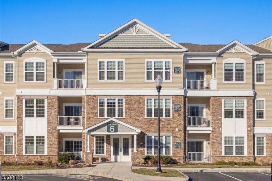 Experience refined, low-maintenance living in this beautifully maintained Kittatinny model in the sought-after Greenbriar at Fox Ridge 55+ community. Ideally positioned on the first floor near the main entrance, this residence offers easy access and tranquil views of the heated outdoor pool and clubhouse. Owned by the original owner, the home reflects pride of ownership throughout.The elegant kitchen features granite countertops with an extended overhang for bar seating, stainless steel appliances, custom tile backsplash, and porcelain tile flooring, creating a polished space for both daily living and entertaining. Hardwood flooring flows throughout the home, enhancing the bright, sun-filled interior. A versatile nook provides flexible space ideal for a dining area, sitting room, or home office.The spacious primary suite offers a custom walk-in closet, reading/desk area, and a spa-inspired en-suite with a glass-enclosed shower, built-in seating, and porcelain tile finishes. Step outside to the private porch with sliding door access, perfect for enjoying peaceful pool views.Additional conveniences include an assigned indoor garage parking space conveniently located near the elevators, with a private storage unit directly behind it. Residents enjoy access to a clubhouse, fitness center, indoor and outdoor pools, tennis and bocce courts, walking paths, and a full calendar of social activities, all minutes from shopping, dining, and major roadways.