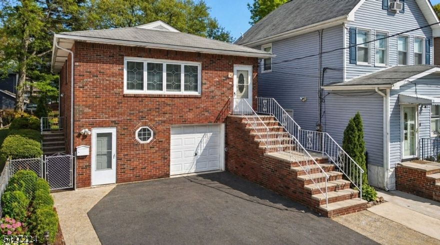 4 Brs / 2 Bths custom brick colonial in the Upper Ivy Hill section of Newark, offering over 3,462 sq. ft. of living space with a true self-contained mother/daughter suite. Layout includes 3 Brs, 1 Bth, kitchen, living, and dining areas on the upper level. Lower level offers the fully self-contained 1 Br, 1 Bth in-law suite with kitchen, pantry & Liv/room. Upper level features formal Liv/D rooms with h/wood floors and double-hung sash windows with an abundance of natural light. The chef's kitchen features granite countertops, oak cabinets and a full appliance package including a gas range with hood, dishwasher, and refrigerator. The S/S double sink comes with a high-arc integrated faucet, while the center island with built-in cabinets anchors the kitchen. Recessed lighting and custom tile finishes come together, making this kitchen a magnificent centerpiece.  All 4 brs are oversized, offering spacious layouts and exceptional closet space. Both full baths are updated, with the main bath featuring a granite double vanity, rich wood cabinetry, and a soaking tub/shower with full-height designer tile and accent band. Brushed nickel fixtures, integrated shelving, a framed mirror and enhanced lighting gives a spa effect. Additional features: Central A/C & heat, attached garage, parking for 3 cars, Laundry/r, and paved rear patio with direct access from in-law suite. Proximity to NYC transit, major highways, 15 min to NWK Airport, 35 min to Manhattan, and steps to Ivy Hill Park.