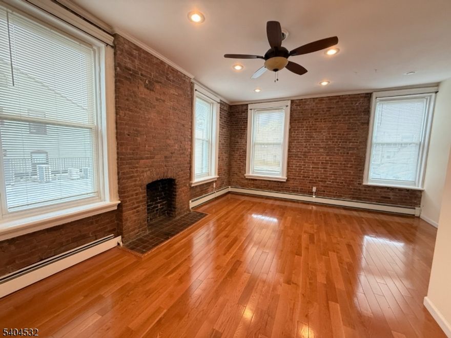 When modern meets classic, this one is for you! Large and charming 1 bed / 1 bath second-floor apartment in the heart of downtown Montclair- literally off of Walnut St. Features beatiful hardwood floors, exposed brick walls, cathedral ceilings recessed lighting, and ceiling fans throughout. Spacious living\dining area with room to work from home. Fully equipped kitchen and full bathroom with tub\shower. Expansive sun-filled bedroom with ample closet space and built-in shelves (accommodates a king size bed and more). One assigned off-street parking space included. Laundry available in building via basement (no in-unit laundry). Prime location with the Walnut Street train station to NYC directly across the street and easy access to shops, dining, and the incredible Wlanut Farmers Market on Saturdays. No pets, sorry.