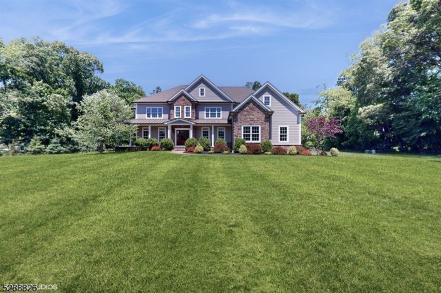 Gorgeous custom built home in a private setting on over 4 acres of land. This home boasts of elegant finishes, beautiful hardwood floors throughout, and spacious rooms everywhere you look! The first floor layout welcomes you with an eleagant formal dining room, roomy living room and beautiful entry that  leads you to a famulous gourmet kitchen! Past the kitchen is a first floor bedroom suite with private bath. The eat-in kitchen features a large center island and quartz countertops, a 6-burner stove, high end appliance and tons of cabinetry! Upstairs you'll find an enomous Master suite with dual closets, a Princess suite as well as 2 large bedrooms with a jack and jill bath. High ceilings throughout the home with the second level hallway overlooking the living room which houses a gas fireplace. Since the septic system is out front, the backyard is just perfect for your personalization! There is plenty of room for a pool, tennis or pickleball courts and/or your outdoor kitchen!  There is a large trex deck off the Great Room, that allows you a quiet relaxing spot morning, noon or evening. Picture yourself entertaining in this beatifully appointed custom home! .