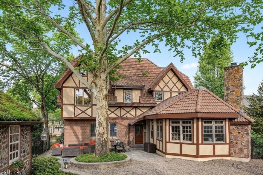 Distinctive Tudor-style home on Aurora Street offering architectural character, quality construction, and extensive improvements over time. Originally built in 1959 and completely rebuilt in 2010 with additional kitchen and landscaping updates completed in 2020 and 2023, the home blends classic design with modern systems and thoughtful updates.Inside, the dramatic great room features vaulted wood ceilings with exposed beams and a stone fireplace, creating a striking focal point for everyday living and entertaining. Hardwood flooring runs throughout much of the home, and the flexible layout includes first-floor bedrooms and full bath for added versatility.Comfort is enhanced by radiant hydronic floor heating and multi-zone central air conditioning, while a concrete tile roof installed in 2010 adds durability and long-term value.Outdoor spaces include a private courtyard setting with mature trees and a charming garden shed, ideal for relaxing or entertaining. A rear alley provides access to a detached garage and private parking area with a gated entry designed to accommodate vehicle access.Located near the Delaware River and just minutes from downtown Easton, Lafayette College, restaurants, shops, and major commuter routes including Routes 22 and 78.