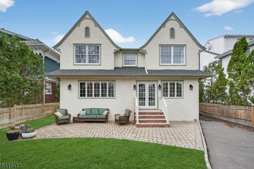 Ideally located in the desirable South Mountain neighborhood just blocks from the Midtown Direct train to NYC, top-rated schools, Taylor Park and vibrant downtown, this expanded custom home offers 4 bedrooms and 3.5 bathrooms blending timeless charm with modern updates. The open-concept layout features hardwood floors, crown molding, and abundant natural light throughout. The inviting living room showcases a wood-burning fireplace with a custom marble mantel. The chef's eat-in kitchen (2021) is designed for everyday living and entertaining with crisp white shaker cabinetry, quartz countertops, Jenn Air 48  gas range, large center island, pantry and access to an oversized mudroom with built-ins, powder room access plus French doors leads to private backyard. The dining room seamlessly connects to both the kitchen and living areas. The spacious family room offers built-ins, window seating and the perfect setting for relaxation or game nights. Upstairs, the primary suite includes 2 closets and a beautifully appointed bathroom with Victoria & Albert clawfoot tub and large shower. 3 additional bedrooms feature custom closets, great natural light and access to a hallway bathroom and convenient 2nd floor laundry. The finished lower level includes a recreation room, office, flexible bonus space, full bath, multipurpose area and ample storage. The fenced backyard features a paver patio, newer driveway and access to a 2-car detached garage.