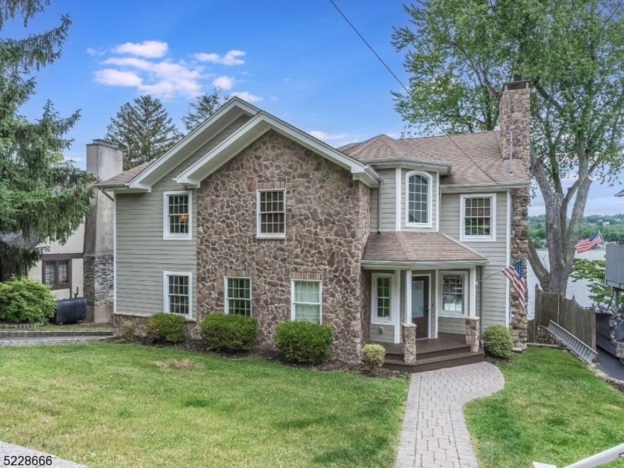 This Lake Mohawk Custom Colonial is located in a highly desirable parkway location providing easy access to recreational activities and the waterfront. Its prime location offers residents the opportunity to engage in various water activities & enjoy the lake through its custom boat dock. One of the standout features of the property is its majestic views of Lake Mohawk, providing a picturesque backdrop and allowing you to immerse yourself in the natural beauty of the area. The grand rear deck offers a spacious outdoor space where you can relax, watch beautiful sunsets, and enjoy the serene surroundings. The kitchen is a highlight of the home, featuring beautiful granite countertops, a center island, two sinks, a wine cooler, cherry custom cabinets, and SS appliances. This gourmet kitchen is not only functional but also provides an inviting space for cooking and entertaining guests. The home offers flexibility with a 6th bedroom EnSuite setup, allowing for various living arrangements to accommodate your needs. Additionally, there is a second-story family media room that can be utilized for relaxation or as an entertainment space, complete with a bathroom. The luxurious primary suite adds an extra touch of elegance to the home, featuring a trey ceiling & a Juliet deck overlooking the lake. This private retreat offers a serene and tranquil atmosphere. A finished basement provides additional living space & convenience, serving as a versatile area for various purposes.