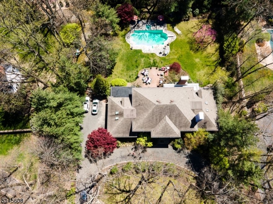 TIME TO ESCAPE To Your Own Resort!!  Elegant custom built Colonial on almost an acre of professionally landscaped property. 6,300+ SF of luxurious living space.First flo First floor has living  (gas fpl), formal dining room, over sized  family room with gas -ignited wood burning fireplace opening to -kitchen, laundry with desk area, office/library, guest suite with bath and 2 powder rooms. Second floor has principal master bedroom suite with gas fireplace, closet room, full bath with over sized soaking bath, steam shower, bidet and double vanity sinks.. Four more bedrooms  (2  ensuite) , main bath and second laundry room. Basement has wine cellar room, fitness room, storage , utility room, powder room, plus a bonus open area  with TV ,billiard and playroom. Lovely private patio  opening  to large gunite pool with spa. This is a perfect house for entertaining. 2 new, furnaces and AC units.