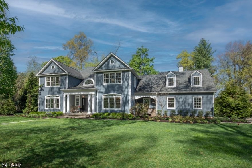 Town and Country are distinctly brought together at Six Westminster Place, ideally situated in a desirable Morris Township cul-de-sac adjacent to Spring Brook Country Club, enjoying peaceful, enduring park-like views and a thoughtfully composed layout.  A covered stone entry introduces a gracious two-story foyer with hardwood floors and transom windows. The dining room, enhanced by refined moldings, flows seamlessly to a well-appointed butler's pantry with custom cabinetry, stone counters, copper sink, and refrigerator. French doors reveal a music room, where tranquil views of the property create a serene setting. The kitchen is both timeless and functional, featuring white inset cabinetry, stone counters, and a substantial center island with complementary cabinetry and Carrara marble top. A built-in banquet offers an inviting dining space, while professional-grade appliances, a pantry, and open flow to the family room support effortless daily living and entertaining. The family room, anchored by a fireplace, opens through French doors to the patio. The first-floor primary suite presents a private retreat with a tray ceiling, fireplace wall, walk-in closet, and a bath with jetted tub, glass-enclosed shower, and dual vanities.The second level offers four additional bedrooms, including multiple en-suite options, along with a secondary family room and dedicated workspace. A high-ceiling lower level adds versatility with a sixth bedroom, full bath and flexible recreation space.