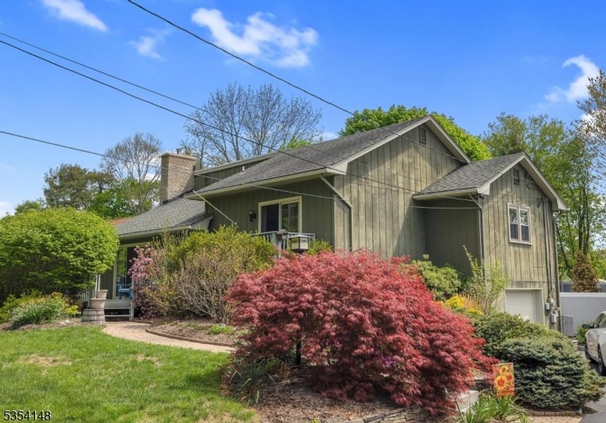 Beautiful contemporary split with open floor plan with hardwood floors, situated on fabulous level lot with perennial beds, raised box vegetable garden, storage shed and plenty of fully fenced yard to play in! Warm and inviting living room with cathedral ceiling with floor to ceiling stone fireplace, woodburning stove insert and recessed lighting with sliders to front deck. Kitchen is less than 10 years old and features stainless steel appliances and granite countertops, breakfast bar and is open to dining room with sliders to deck. Primary suite has sliders to a private balcony and also a full bath with stall shower, less than 8 years old. 2 additional large bedrooms and full bath round out the living space. There are pull down stairs to attic storage and a full, walk-out lower level including family room with pellet stove and sliders to patio, laundry room and lots of storage. Gutter guards, usable backyard, apoxy garage floor, closet built-ins are just some of the upgraded items done recently. More information about updates/upgrades in media section. Convenient to Rts 46 and 80, shopping and dining, lake activities and more!  Resort living year round! Second fridge in basement staying. Pool can either be taken down or remain. Membership to Lake Lackawanna is optional at approximately $625. Natural gas expected to come to neighborhood in 1-2 years. **Contingent upon sellers finding a suitable home to buy**