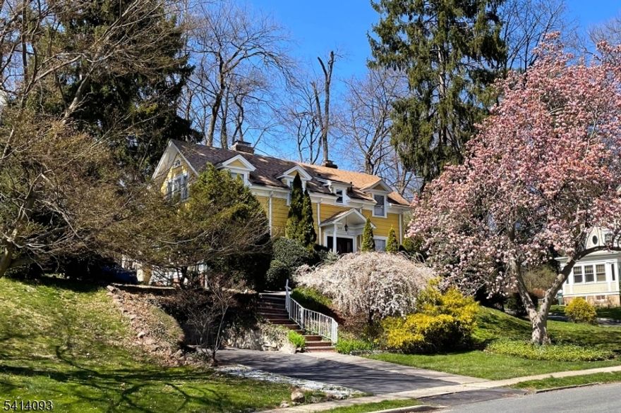 This turnkey 3 bed 3.1 bath colonial just steps away from Flood's Hill is the one you've been waiting for. Ideally located a short walk to town, train, schools, shops, restaurants, SO pool, Meadowland Park, and the Baird rec center. The first floor offers sun-drenched rooms and gleaming hardwood floors and boasts a large, open kitchen with center island, stainless steel appliances, and separate breakfast area and flowing to a spacious formal dining room. The living room with wood burning fireplace and adjacent sunroom / family room provide ample space for entertaining or relaxation. A powder room completes this level. Upstairs, the primary suite features lovely, large windows providing tons of light and views of Flood's Hill. Plus multiple closets and an en suite bath. There are two additional spacious bedrooms and an updated full hall bath with double sinks. Downstairs, the finished basement includes a large rec room for more lounge space, plus a workshop, laundry room, storage room,  bonus room and full bath. The expansive patio is the perfect place to relax and immerse yourself in nature. Don't let this one get away!