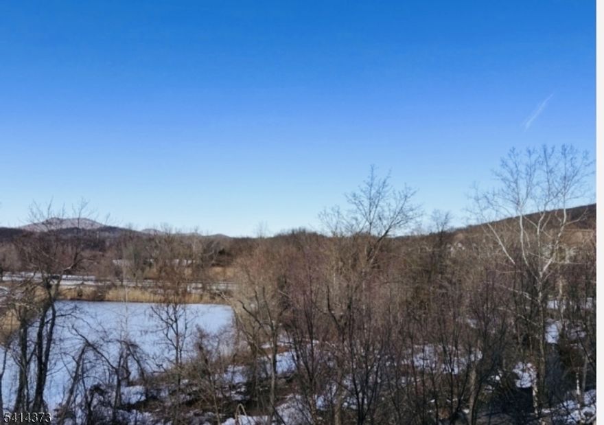 Location within a location.!  Panoramic mountain views make this penthouse condo a stand out.  This is a private and gated adult community for discerning and active residents.  Enjoy the clubhouse which offers an indoor pool, fitness room, cafe, movie theater, craft room, sauna, billards, a ballroom reception area where you can sit by the fireplace, have a bite to eat, play cards and gather.  The clubhouse is a short walk across the road from building 9.  Outdoor activities include a bocci court, tennis, outdoor pool and there's so much more to enjoy while living at Wanaque Reserve. The large eat-in kitchen is equipped with a pantry closet, ample cabinetry and plenty of counter space with access to the laundry room with the washer & dryer included and a brand new water heater.  A formal dining room for hosting dinners and everyday meals.  The living room with sliding glass doors opens to the private balcony with a storage closet and the best view of the mountain range and nature showing its best during each season.  Both bedrooms, the den and living room also look out onto the view.  French doors open into the den which can be used as a TV room, home office or to suite your needs. The beautiful hardwood flooring runs through the main living area.  Located on the 4th floor this unit is only steps away from the elevator.  Then it comes with 1 garage parking space. This truly is a wonderful place to call home.