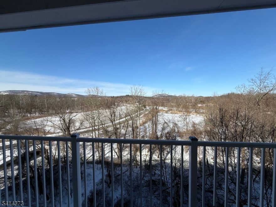 Location within a location.!  Panoramic mountain views make this penthouse condo a stand out.  This is a private and gated adult community for discerning and active residents.  Enjoy the clubhouse which offers an indoor pool, fitness room, cafe, movie theater, craft room, sauna, billards, a ballroom reception area where you can sit by the fireplace, have a bite to eat, play cards and gather.  The clubhouse is a short walk across the road from building 9.  Outdoor activities include a bocci court, tennis, outdoor pool and there's so much more to enjoy while living at Wanaque Reserve. The large eat-in kitchen is equipped with a pantry closet, ample cabinetry and plenty of counter space with access to the laundry room with the washer & dryer included and a brand new water heater.  A formal dining room for hosting dinners and everyday meals.  The living room with sliding glass doors opens to the private balcony with a storage closet and the best view of the mountain range and nature showing it's best during each season.  Both bedrooms, the den and living room also look out onto the view.  French doors open into the den which can be used as a TV room, home office or to suite your needs. The beautiful hardwood flooring runs through the main living area.  Located on the 4th floor this unit is only steps away from the elevator.  This truly is a wonderful place to call home.