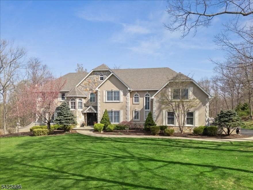 Elegant and grand inside and out, this exceptional residence in sought-after Sussex Mills offers refined living at its finest. Masterful design and modern luxury define this spacious Colonial is set on nearly 2 acres of private, park-like property. The interior showcases generous room sizes, elegant architectural details, and hardwood floors throughout. Expansive entertaining spaces extend outdoors to a large deck and heated saltwater pool with a beautifully designed patio, perfect for gathering, dining, and relaxing in a serene setting. A dramatic 2-story foyer opens to a formal dining room with butler's pantry, living room, a 1st-floor bedroom with en-suite, and a stunning family room with fireplace and a 2-story wall of windows. The chef's kitchen features white cabinetry, ample counter space, an oversized island, high-end appliances, and a bright breakfast nook, with sliding doors leading to the deck. A powder room, pantry, and mudroom/laundry and garage access complete the main level. Upstairs, the primary suite offers a sitting area with fireplace, spacious walk-in closet, and spa-like bath with dual vanities and a jetted tub. 3 additional bedrooms include 2 with en-suite baths and generous closets. The finished walkout basement includes a rec room, game room, bonus space, full bath, and storage. A 2-zone geothermal system adds efficiency. Perfectly positioned, easy access to year-round recreation, close to Rt15, I-80, and nearby charming downtowns.