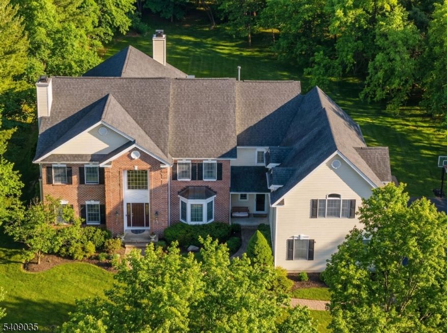 Welcome to this NW-facing custom brick-front Colonial, set at the end of a beautiful cul-de-sac. A gracious entry introduces the home's generous scale, natural light, and seamless flow, creating an immediate sense of warmth that continues throughout. The chef's kitchen, designed for everyday living and entertaining, features a large center island, granite countertops, Viking 6-burner range, double oven, white cabinetry, pantry, and a bright breakfast area that opens to the family room with gas fireplace. The primary suite is a true retreat with its own foyer, and offers a sitting area, spa quality updated bath and two walk-in California Closets. Hardwood flooring is complemented by 9-foot ceilings on both the first and second levels.The home offers 5,000+ SF, six bedrooms, 4.2 baths, plus a custom finished basement with home theater (projector 2024), luxurious seating, custom bar, full bath, gym area, and recreation space. Additional features include an 8-zone prewired speaker system, smart-home technology with Ring alarm, cameras, and MyQ garage opener, a built-in gas generator, freshly 2026 painted interior, updated primary and guest baths, architecturally enhanced first-floor moldings, and an epoxied garage floor. Set on 1.09 acres of level, park-like property, the home is surrounded by mature trees and features a paver stone driveway, walkway, and expansive stone patio. Centrally located, enjoy convenient access to award-winning schools, shopping, and transportation.