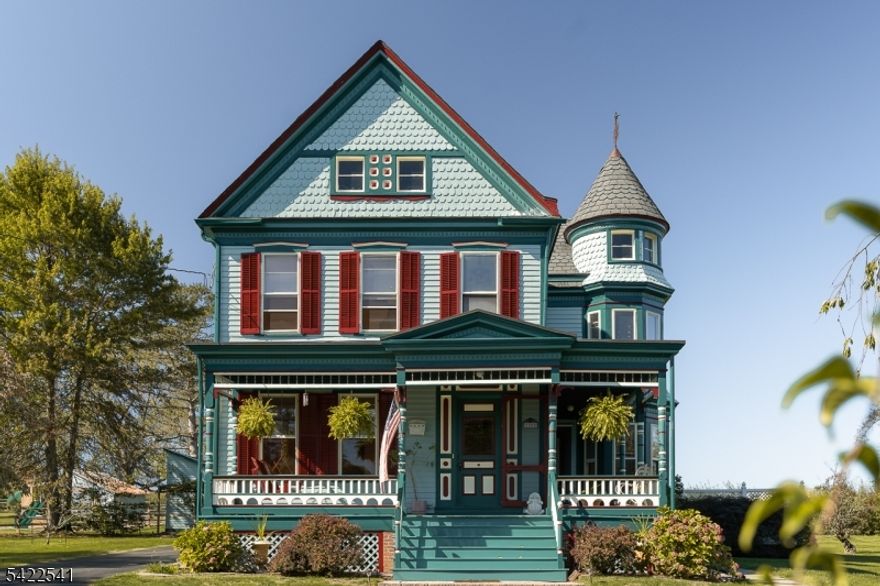 This 1894 Queen Anne Victorian stands as one of Tewksbury's most iconic homes and a beautifully preserved example of early American architecture. From the signature wraparound porch to the intricate millwork and striking five-color exterior (freshly painted in 2025), every detail reflects craftsmanship from another era. Recently refreshed with a full interior repaint and refinished original hardwood floors, 25 Old Turnpike Road presents with a renewed sense of lightness and cohesion, honoring its history while feeling move-in ready. Inside, original moldings, pocket doors, hardwood floors, and elegant bay windows frame rooms filled with natural light and character. The home offers four bedrooms, 1.5 baths, and a walk-up unfinished third floor brimming with potential, ideal for a studio, playroom, or additional living space. A detached garage and versatile outbuilding provide flexibility for a workshop or office. Located in the heart of Oldwick, this home is more than a residence, it's a piece of the town's architectural story, thoughtfully maintained and ready for its next chapter.