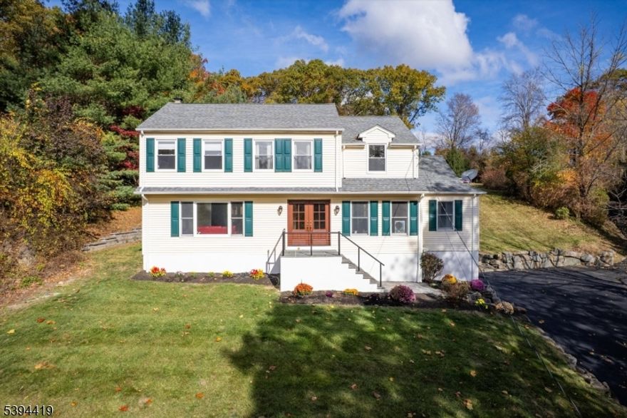 Welcome home to this charming Colonial perched on a peaceful hilltop with beautiful views of the rolling countryside. Set on 1.1 acres, this lovingly updated home offers the perfect blend of comfort, style, and space for living & growing. The owners have thoughtfully invested in major 2025 updates, including a brand-new driveway, front steps and railings, paver walkway, and a completely renovated kitchen with stunning new flooring that continues into the laundry room which has also been painted.  In addition most of the rooms are newly painted including the rec room and garage on the basement level, and all second-floor windows replaced for peace of mind. The roof, central air condenser and water heater are under 10 years old, and stylish new lighting brightens the kitchen, foyer, hallway, and dining room. The first floor features gleaming Santos mahogany floors, while the family room's wood-burning fireplace and sliders to the spacious paver patio with hot tub and fire pit make it easy to gather and enjoy cozy evenings or summer barbecues. With 4 bedrooms, 2.5 baths, a 2-car attached garage with newly painted speckled floor, and a partially finished basement, this home has been beautifully prepared for its next happy owners.  Close to Routes 10, 46 and 287 to enjoy dining and shopping, then you can retreat to your beautifully updated home with a private peaceful setting.