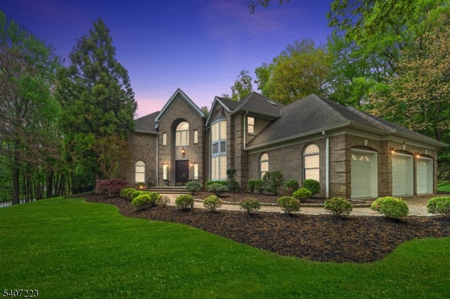 Situated in the highly desirable East Hill neighborhood, this impressive 7,531 sq ft brick Colonial is set on nearly an acre of landscaped grounds with an in-ground heated pool. Built in the 1990s and renovated in 2018, the home features a grand two-story foyer, expansive chef's kitchen with high-end finishes, formal dining room, sun-filled living room, and family room with fireplace. A flexible library or guest suite with full bath completes the main level. The second floor offers a luxurious primary suite with spa-like bath and soaking tub, plus three additional bedrooms with en-suite baths. The fully finished lower level includes a billiard room, gym, theater, custom wet bar, and additional bedroom with full bath. Located in a top-rated school district with convenient access to Manhattan, this exceptional home offers refined living and outstanding indoor-outdoor amenities.