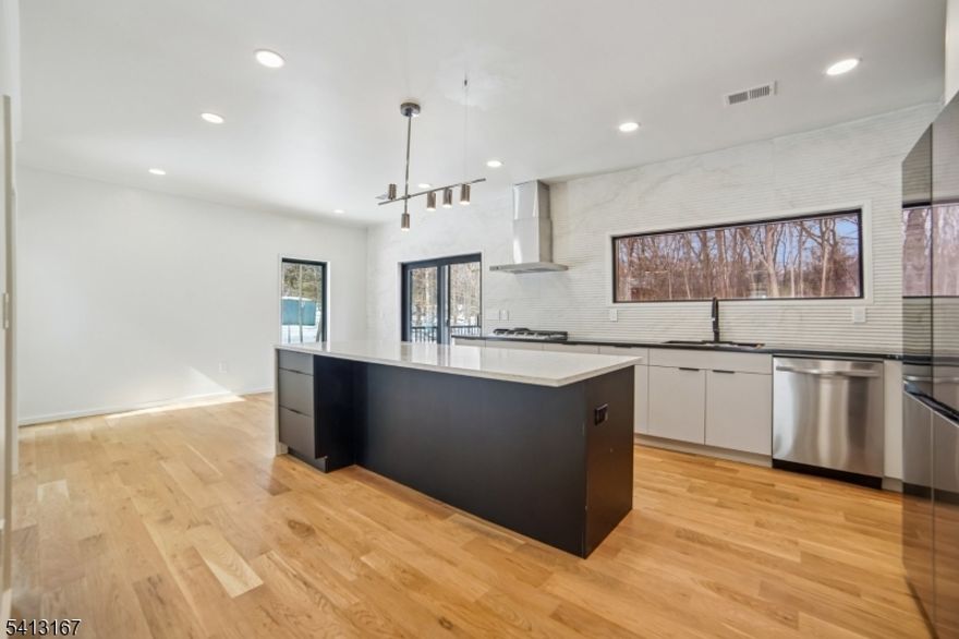 Turnkey - Reimagined with a back addition, renovated & full remodel - Custom unique expansive & open floor plan. Over 3400 Sq ft on 1. 8 Acres - Dramatic curb appeal from the circular driveway. Modern stucco & techwood vertical siding complements the black 8 ft European steel front door & oversized aluminum windows. Everything is sun lit - living room with gas fireplace, dining room with additional seating area. WOW kitchen is what home chefs dream of! Breakfast area, huge Island, cabinets, quartz counters & smart appliances. Convenient powder room & steps down to a family room. Guest bedroom with a bath on this level, laundry room & access to garage with tiled floors, EV charger & wifi door openers. Master bedroom with ensuite & balcony to watch the serene nature. 2 other bedrooms & bath on this level. All closets are walk in with organizers & bathrooms have LED mirrors & towel warmers. 800 + Sqf finished lower level offers versatile options. Designer features & fixtures -Wi-Fi enabled 4 zone gas HVAC, exterior lighting, cameras, hardwired TV outlets & ports. New flooring, accent walls, floating stairs, metal railings, solid doors, driveway, electric, insulation (even between floors & walls), plumbing, water softener & hot water heater. Huge Trex deck with gas connection for the grill. The incredibly private wooded backyard offers a retreat to destress or host perfect for summer gatherings. City utilities. Just minutes to highways, NYC train, schools, shopping & restaurants.