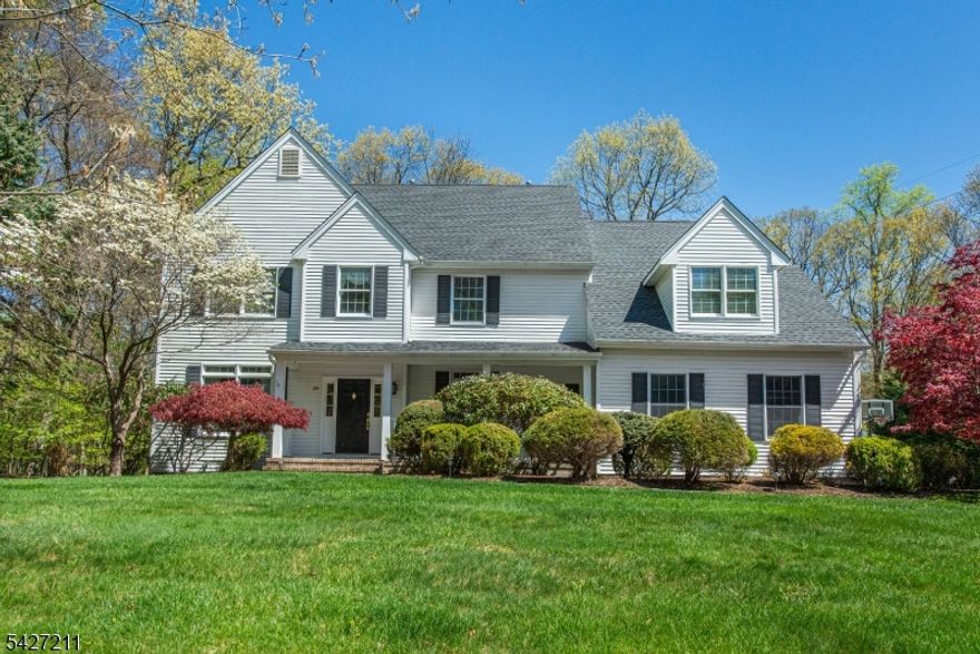 Spectacular Colonial home located in the desirable Center Grove section of Randolph offers exceptional curb appeal & a welcoming front porch. this four bedroom, two and half bath home with an oversized two-car garage w/ PVC custom tile flooring. Enjoy 9' ceilings throughout the main level. 10' ceiling in step down living room. Gleaming hardwood flooring throughout. Magnificent 2021 kitchen showcases white granite countertops, large center island w/ second sink, custom subway tile backsplash along with Mosaic backsplash over stove, Sub-Zero refrigerator, Viking six burner range w/ industrial exhaust fan in custom hood, custom lighting in cabinets & a built in microwave in island. Kitchen opens seamlessly to a spacious family rm w/ vaulted ceilings & a gas fireplace, overlooking a private, flat backyard. Enjoy outdoor living on the expansive deck and a convenient storage shed in back. Additional main-level highlights include private home office w/ French doors, two-story entry foyer & a laundry room. Second level features four well-appointed bedrooms. The primary suite boasts two walk-in closets & a beautifully renovated bath featuring luxurious custom lighting, a stand alone soaking tub, dual-sink vanity, & large custom tiled shower. Finished lower level offers a home gym w/ rubber matting flooring & a spacious recreation room with abundant storage. Four year young roof & so much more! Ideally located near parks, schools, shopping, & Randolph Trails! Do not miss this one!