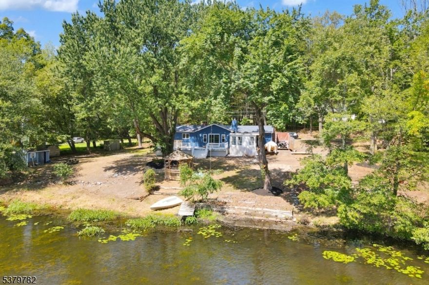 Enjoy peaceful lakefront living in this beautifully renovated ranch home, set on an oversized 0.45-acre lot in the desirable Crandon Lakes community. This one-level home offers 3 bedrooms, 2 full baths, and a spacious, light-filled layout designed for easy living and entertaining. The updated kitchen features all-new appliances, a center island, and lake views that make cooking a joy. The living room is warm and inviting with a cozy fireplace and sliders that lead out to a wraparound deck perfect for gatherings, morning coffee, or evening sunsets over the water. New flooring runs throughout the home, and a large laundry/mudroom with floor-to-ceiling cabinetry adds practical convenience. A side door off the deck makes daily life seamless. The three-season room with hot tub is a standout, offering a relaxing space to unwind while taking in lake views well beyond summer. The finished basement provides additional flexible space for a home office, gym, or storage. Whether you're looking for a full-time residence or a weekend retreat, this lakefront gem combines comfort, style, and serenity. The backyard has been cleared and is your canvas for the ultimate lakeside oasis! Crandon offers residents an array of amenities and community events. The playground and pavilion are ideal for fun-filled gatherings and feature live music on Friday nights during the summer. Plus 2 beaches, boating and fishing to enjoy all summer long.