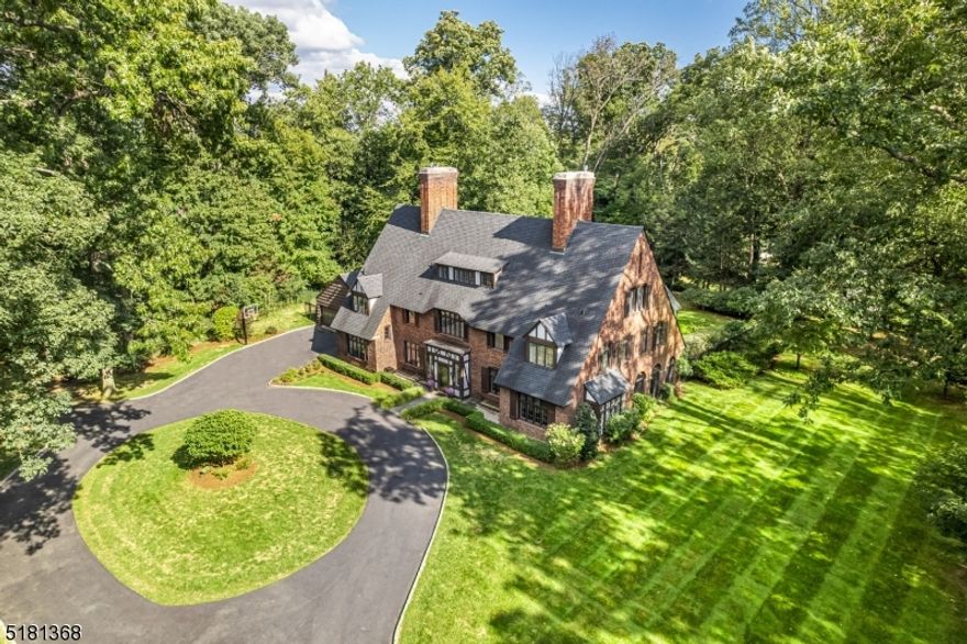 Welcome to this gracious, English Manor home in desirable Convent Station w/ easy walk to Mid Town Direct train & close to downtown Morristown/Madison. This 1.8 acre estate features 6 BR's, 5.1 BA's w/ high ceilings, stunning windows & doors, beautiful hrdwd flrs & period details thru-out. The foyer flows into the gracious LR. This rooms' beautiful mantle, gas fireplace and dramatic double French doors create a gorgeous space for entertaining & flows into the porch w arched screened windows, a brick fireplace & access to the blue-stone patio... perfect for a party! The stunning formal DR w/ detailed mantle, fireplace, & French doors to the patio, flows easily into the gourmet kitchen w/ large quartz island, breakfast nook,  brick hearth & gas fireplace, & mud room. The sunroom off the kitchen can be a playroom or den w/ arched windows & French doors to the patio & fabulous yard.  The family room/den w/ fireplace, exposed beam ceilings & beautiful windows and floors offers the perfect gathering spot or a great private office. The primary suite features a beautiful decorative fireplace and a gorgeous new spa-like bath with oversized shower, claw-foot tub, double-vanity, & built-in dresser. A walk-in-closet/dressing area and two additional closets offer ample closet space. 3 additional BR's, 2  are ensuite, a hall bath & laundry complete this level. The 3rd floor offers a large rec room, a full bath, an office/BR and a media/BR. Many recent updates throughout!