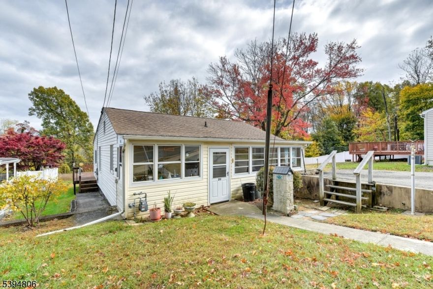 Three bedroom and one bath ranch with a back deck off of the living room. Plus a front three season screened in porch.