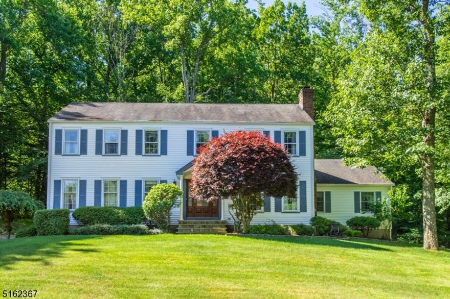 Lovely, Welcoming Colonial in the desirable Robin Hill/Union Hill section of Denville! Private property nestled within a lovely neighborhood. Extremely Well maintained, Original Owners.  Warm and cozy Family Room w/ WB fireplace. Large eat-in-kitchen boasts tons of counter space & slider to stunning back deck. Magnificent first floor layout includes Formal Living & Dining. Powder room, laundry & BONUS 5th bedroom w/ suite- second kitchen & full bath. Gorgeous hardwood flooring throughout. Upstairs, the primary Suite offers a walk-in closet, a vanity area & en-suite bath. 3 Additional generous sized bedrooms & the 3rd full bath complete the floor. The spacious basement offers easy access off the 2 car garage and residential chair lift for ease! Nicely landscaped, grassy lawn for enjoyment, plus large deck backing private, wooded oasis. Great yard, low maintenance.  A showcase home! Low taxes for size home & over 1 acre of property. Excellent schools, close to shopping, restaurants and mass transit (bus and train) into NYC.