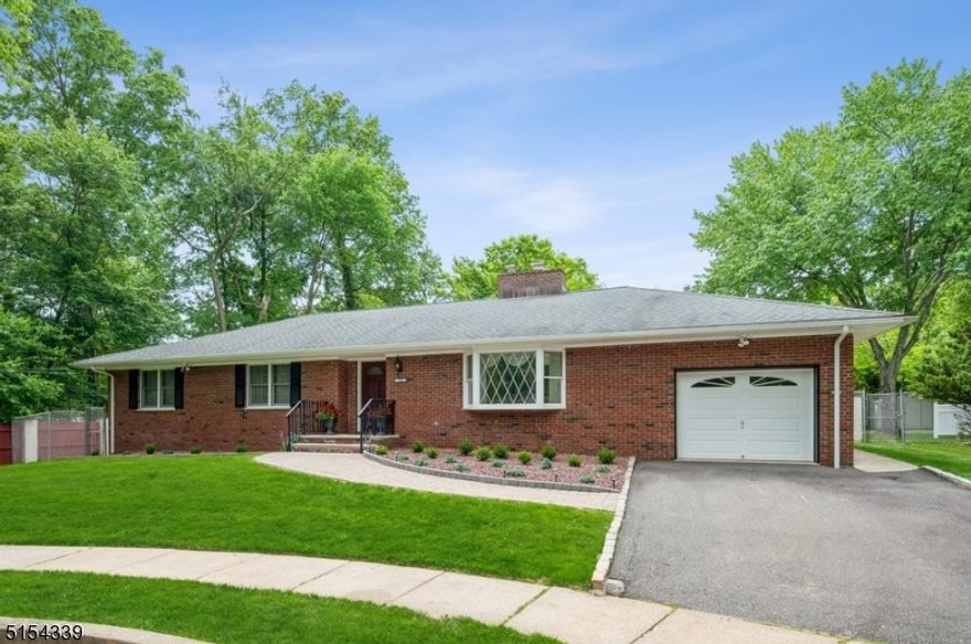 Impeccable home in a superb location! Elegant custom Ranch sits on a newly landscaped lot on a quiet cul-de-sac in highly desirable neighborhood. A stone pathway & beautifully manicured grounds invite you into the front entry. You're greeted by rich hardwood flrs & a bright, open floor plan seamlessly connecting the kitchen to the LR & DR. This home includes 2 primary bedroom suites, each with its own full en-suite baths, one w/a walk-in closet & access to the upper patio. Two additional bedrooms, a full renovated hallway bath w/double sinks & a half bth/laundry rm off the kitchen w/a convenient side entrance to the pool area. The entertaining spaces flow outside to the gorgeous back yard boasting an upper patio right off the kitchen & a sprawling lower patio around the heated in-ground swimming pool. Meticulous attention to detail is presented in the eat-in kitchen featuring quartz counters w/customized backsplash. SS appliances include a double wall oven & a stylish range hood over the cooktop on the center island. Highlights include brick wall exterior construction, a beautiful stone surround wood-burning fireplace in the LR, a recently finished walk-out basement offering a spacious rec-room, a large walk-up attic, a stainless-steel grill connected to the house gas line & an attached o1-car garage.  This home is just minutes to the train station, stores, rest, parks & blocks away from top-rated school district. TOP FEATURES & UPDATES addt'l disclosures on media.