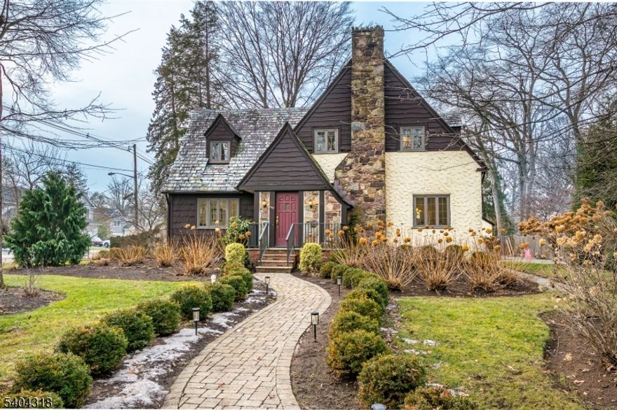 Storybook Tudor Revival in the heart of Metuchen. Exceptionally maintained and beautifully updated, this classic English Tudor Revival home blends timeless architectural charm with thoughtful modern upgrades. Set on a picturesque lot, the home features a striking stone chimney, steep gabled rooflines, and a warm, inviting facade that immediately captures attention. Inside, you will find 4 bedrooms, 2.5 baths, and a layout designed for both everyday living and entertaining. The living room is anchored by a wood-burning fireplace, creating a cozy focal point, while the home's character rich details are complemented by tasteful updates throughout. Finished basement offers space which can be utilized as a recreation room, home gym, home office and a space for guests with a full bathroom. Basement has a proper exit egress. Major updates include 2 new furnaces, central air conditioning, new sewer line, and much more. Exterior highlights include large lot, two-car detached garage, lovely patio and play area, spacious driveway, and charming architectural details throughout exterior. Located just minutes away from Metuchen vibrant downtown, YMCA, NYC/Philadelphia train. This is a rare opportunity to own a storybook Tudor/Classic English Tudor Revival, in a premier Metuchen setting, where classic charm meets modern comfort.