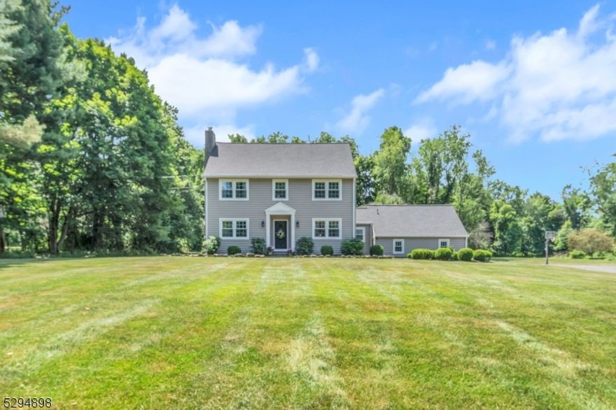 Set on top of a knoll, beautiful, updated Nantucket saltbox colonial overlooking private 3+ acres with not a thing to do!  Bright and neutral decor with hardwood flooring throughout, living room with wood burning fireplace, family room with beamed ceiling, kitchen with wood cabinetry, farm sink and stainless appliances, four spacious bedrooms, updated baths, partially finished basement.  Other features include central air, patio with hot tub, composite deck, roof and oversized gutters in 2023, generator hookup, all appliances included, Boiler Mate, Roth oil tank in basement, new well holding tank in 2018, 2 car attached garage with newer doors, windows and siding 2021, under eaves and attic storage.  Long Valley schools and West Morris Central High School with IB Program.