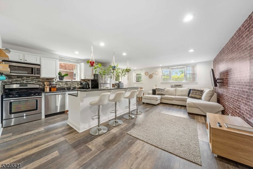 Stunning, renovated in 2021 ground floor condominium, ready for new owner. This gorgeous unit consist of an open floor plan, with updated kitchen with breakfast bar, living room and dining room combo. SS appliances and laminate floors. One large master bedroom with great size closets, totally renovated bath and a den that can be used as desire. One parking spot assigned. Conveniently located laundry room on same floor. Central Air and heating. HOA fee includes heat, water, sewer, maintenance outside, snow removal and gas all except electricity! Making this a great and affordable option.  Prime location, few blocks from bus with direct access to NY and access to two trains stations for easy commute. A must see!