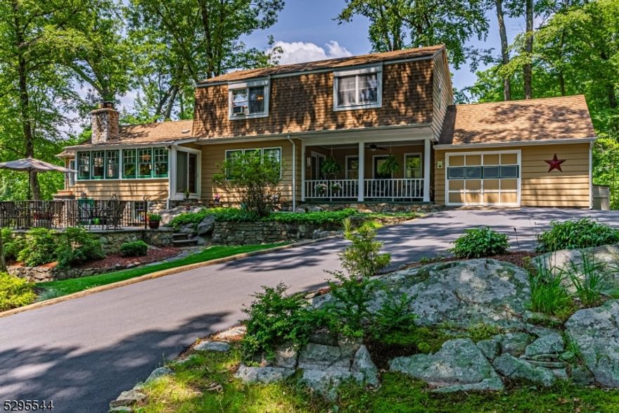 Whimsical and charming expanded Country Style Cottage on nearly an acre of wooded Knoll. A Private, Park-Like Property gift Wrapped in Landscaping, stone walls and an abundance of outdoor living spaces uniquely designed to capture the surrounding natural beauty. Tucked away in the sought after Cedar Lake community. A lemonade front porch welcomes you into a lovely family room with gorgeous hardwood floors. Nicely remodeled and classic kitchen with stainless steel appliances, gas cooking and a formal dining room with a wall of windows. Large living room, great for entertaining with your classic "lakestyle" stone fireplace. A handsome first floor bedroom, office and full bath. Upstairs, an additional 3 generous sized bedrooms and full bath. Skylight and large windows provide tons of natural light. Many rooms to accommodate a versatile lifestyle.  Cozy yet spacious. The classic charm and privacy provides a wonderful ambience, inside and out. Large laundry/mudroom and a 1.5 car garage. Community Lake activities with membership for all ages - swimming, boating, fishing & many clubhouse events. Short drive to Denville's bustling Downtown and NYC Direct transportation. Easy access to major highways. All of life's conveniences close-by while experiencing peace and serenity. This home may not lay in the Countryside of the British Isles, but the Look & Heart of its Structure Surely Takes one there.