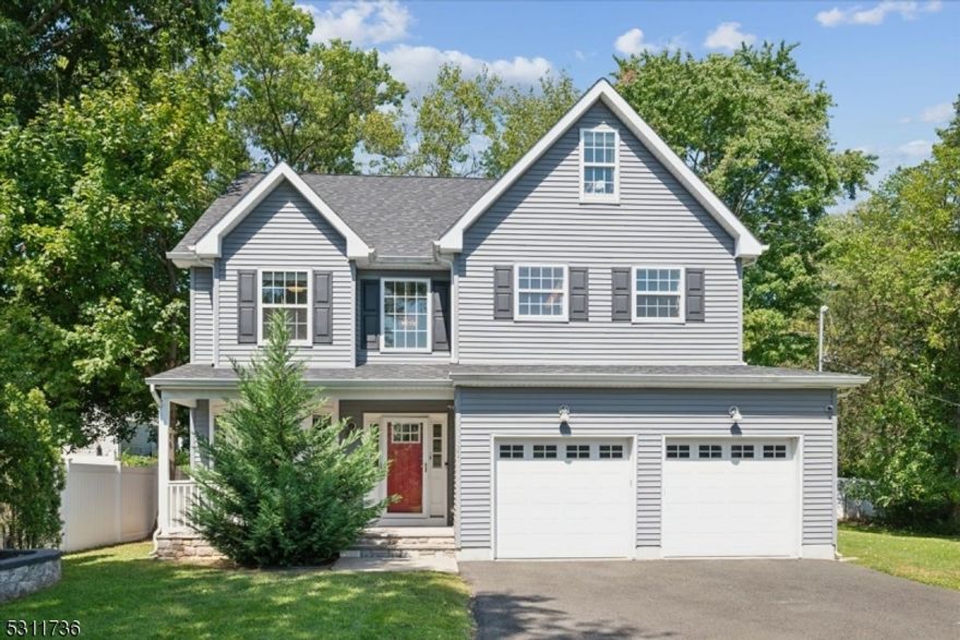 Exquisite Colonial with Modern Touches. This beautiful 6-year-young home blends classic charm, elegance, and contemporary finishes throughout, boasting 4 bed, 2.5 recently updated baths, attached 2-car garage and lots of space for comfortable living and entertaining. Fantastic residential location near shops, restaurants, schools, parks, convenient transit option to NYC, and more. An inviting porch and 2-story foyer usher you inside highlighted by gleaming hardwood floors, crown molding and ample natural light, starting with an elegant formal dining room. Just beyond is the gorgeous updated eat-in kitchen with crisp white cabinets, granite counters, SS appliances all 1 year old, breakfast peninsula and sunny breakfast nook. This space opens seamlessly into a stunning living room with gas fireplace and large windows framing verdant backyard vistas. A powder room and garage access complete this level. The second floor hosts 4 bedrooms, all with wood floors and generous closets, including a large primary with luxurious adjoining bath appointed with ceramic tile, 2 vanities, shower stall and separate top of the line soaking tub. A full bath with shower is down the hall past a convenient laundry closet. Sprawling 3rd floor bonus room is perfect for recreation or office space. Partially fenced property on a quiet street surrounded by mature greenery offers plenty of space for cookouts, gardening and entertaining. Lots of amenities and move-in ready, just unpack and enjoy.