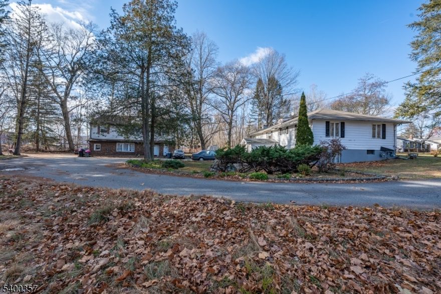 Incredible potential awaits with these two spacious homes. This rare property offers exceptional space, privacy, and versatility perfect for investors, or those looking to create something truly special. This 3.5 acre lot has a ranch style home with 4 bedrooms one full bathroom upstairs with partially finished walkout basement with multiple rooms and full bathroom. Second structure has 2 separate entrances; 1 side has 3 bedrooms 1 full bathroom and kitchen. Second side has 2 bedrooms 1 full bath and kitchen.