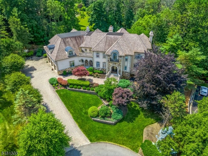Perched at the end of a quiet cul-de-sac in Watchung, sits this architectural masterpiece. With nearly 10,000 sq feet of finished space, no detail was overlooked. This very grand home has an entertainment room on the first floor complete with a wet bar, refrigerator, ice maker, and fireplace! The custom Mahogany library also has its own fireplace. The separate inlaw suite is complete with a living & bedroom area, WIC, and full bathroom. The independent butler's pantry is my favorite! it is adjacent to the oversized dining room and contains extensive cabinetry for storage, its own dishwasher, sink, and granite countertops. The primary suite is really a retreat! This private suite has a fireplace, balcony overlooking the scenic pool, coffee bar with refrigerator, and two custom oversized closets. All finished off with the most exquisite custom moldings and detailing throughout. The walkout finished basement has an eloquent wine cellar, a movie theater, and a sunny ensuite with two large windows. This home is complete with a heated gunite pool surrounded by lush landscaping and a four-car garage with a car lift.