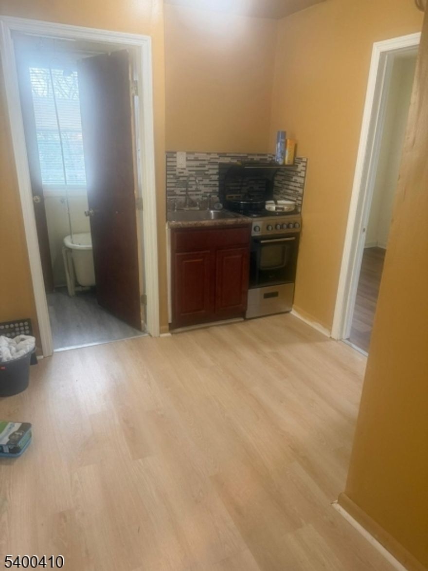 189 Wainwright St, 3rd Floor, offers a clean and well-kept 1-bedroom, 1-bath apartment located in Newark's Weequahic section. This unit features a bright living area, a functional kitchen with cabinet storage, and a well-sized bedroom with natural light. The bathroom includes tile finishes and standard fixtures. No pets, no on-site laundry, and street parking only. Conveniently situated near NJ Transit bus lines, Weequahic Park, shopping, schools, Newark Airport, and major highways, providing easy access to Downtown Newark and NYC commuter routes.