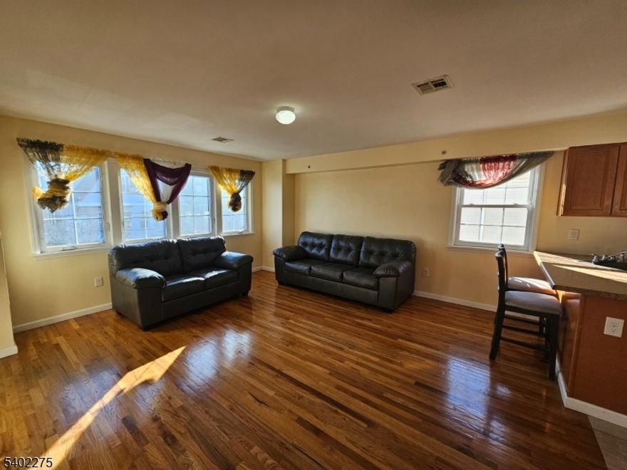 This spacious and sunlit 3-bedroom apartment offers a comfortable and modern living experience with an open, inviting layout. The home features three generously sized bedrooms, including a primary suite with a private bathroom, along with an additional full bathroom conveniently located off the hallway. The open-concept design seamlessly connects the kitchen, dining area, and large living room, creating the perfect space for everyday living and entertaining, all filled with natural light.Ideally located just a walk from Central Avenue, the area?s main thoroughfare, the apartment is close to shops, dining, downtown Newark, and major transportation options. With easy access to buses and trains to New York City, this location is perfect for commuters seeking both convenience and comfort.