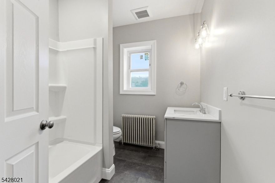 Perfectly situated in the heart of town, this completely renovated second-floor rental offers effortless one-floor living with entrances from both Main Street and the rear of the building. Just steps from charming Main Street and the iconic Lake Mohawk Boardwalk and Plaza, you'll enjoy boutique shopping, dining, summer concerts, and more right outside your door. Tenant pays electric; all other utilities are included. A rare opportunity for convenient living in an unbeatable location.
