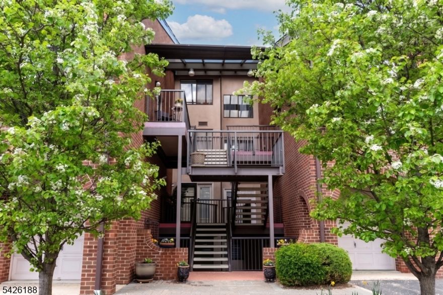 Opportunity awaits you at the highly sought-after Courts of Glenpointe! It is rare when a 2 bedroom, 2.5 bathroom Townhouse becomes available. Here's your chance to step inside to a welcoming entry with a coat closet, leading to a generous dining room that overlooks a sunken living room featuring a wood-burning fireplace and beautiful balcony doors to a private patio. The spacious kitchen has a breakfast bar, stainless steel appliances and cabinetry with plenty of storage. The primary suite offers two large closets and a fully renovated bathroom with a stall shower, soaking tub, oversized vanity and another huge balcony. The second bedroom is equally spacious with a large closet space. Additional highlights include in-unit laundry and hardwood floors throughout. Water is included with the HOA You can walk out your front door to a short flight of covered steps for direct access to your private two-car tandem garage. This gated community provides 24-hour security and amenities including a pool, tennis courts, dog park, and a community room. This is a real commuter's dream , the NYC express bus conveniently stops right at the front gate.