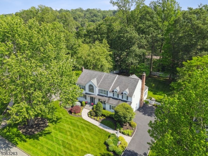 Welcome to this stunning 5BR, 3.1BA Colonial in Chatham's highly sought-after Wickham Woods neighborhood. The heart of the home is the chef's kitchen with a large island, high-end Wolf and Sub-Zero appliances and white and glass cabinetry. The spacious breakfast room w stone wall and gas fireplace opens to a bright family room w vaulted ceilings and French doors to deck. A formal living and dining room plus a stylish bar/den offers wonderful flow for entertaining with beautiful hardwood floors and large windows throughout. Upstairs, the gracious primary suite features a gorgeous spa-like bath with soaking tub and fabulous steam shower, dressing area, and walk-in closet. Another large bedroom offers an additional private suite with full bath. Three more bedrooms share an updated and spacious hall bath. The sunny hallway with window seat is the perfect nook for relaxing. A finished lower level features beautiful new floors and a spacious layout for recreation or work. Step outside to your own private oasis with a large deck, built-in grill/bar area, and a stone patio with gas fire pit. The beautifully landscaped yard has plenty of area for play and gardens. Additional features include 2-car heated garage with large driveway and whole-house generator. Located in the heart of Wickham Woods, enjoy proximity to top-rated schools, Midtown Direct train, BoxCar commuter service and Chatham's vibrant downtown. Please submit offers by 5 pm on June 16th. See guidelines