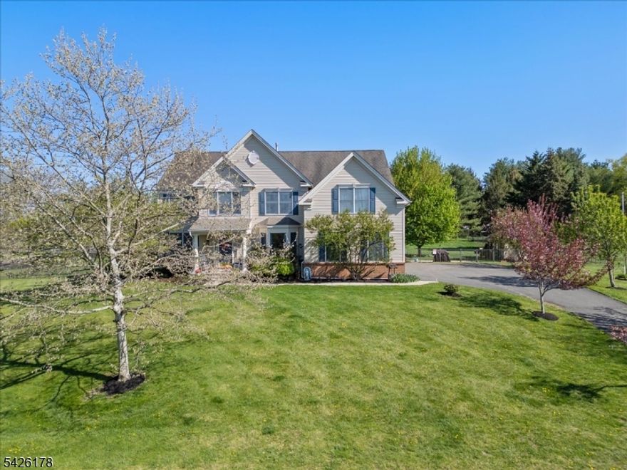 Welcome to 1 Tanager Dr, where comfort, space, and thoughtful design come together in one exceptional home. Relax and unwind on the inviting front porch perfect for rocking chairs and enjoying peaceful mornings or evenings where you can see the sunset.A dramatic two-story foyer welcomes you into a spacious main level featuring a large living room and formal dining room with crown molding, plus abundant windows throughout that fill the home with natural light. The eat-in kitchen offers a center island, tile backsplash, large pantry, and sunny breakfast area. The adjoining family room features a vaulted ceiling and gas fireplace. A first-floor office/den, laundry room, and access to the 2-car garage add everyday convenience.Upstairs, the private primary suite is set apart from the other bedrooms and includes a sitting area, dual walk-in closets, and an ensuite bath with soaking tub. Three additional generously sized bedrooms are located on the opposite side of the home, including one with a walk-in closet, and share a second full bathroom. Linen closets in both the bathroom and hallway provide convenient additional storage. A bonus desk area and access to storage over the garage add extra flexibility.The expansive finished basement offers incredible additional living space, plus two large storage areas and a closet.Situated on over 1.1 acres, the level fenced yard with patio is ideal for outdoor entertaining. Meticulously maintained and move-in ready.