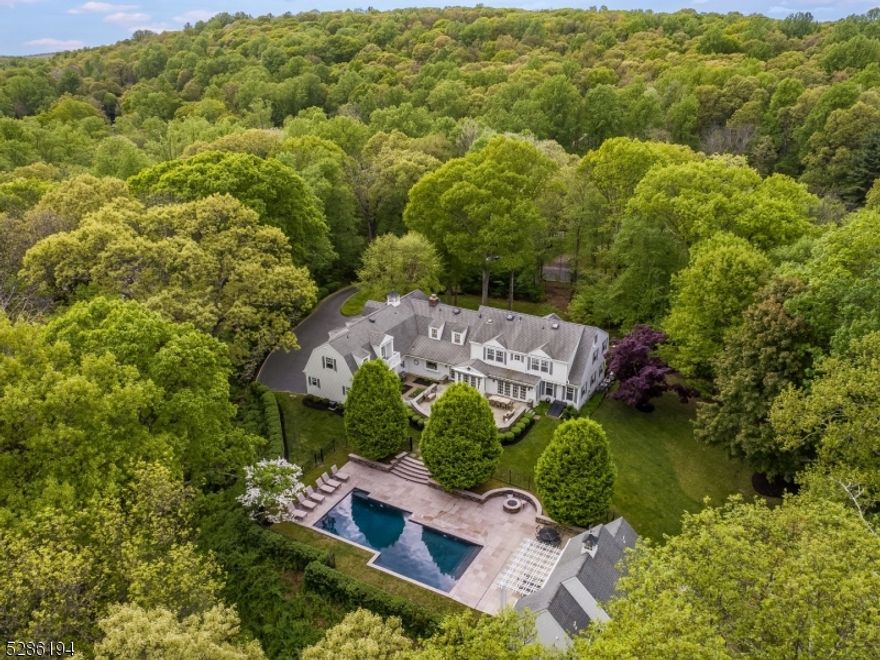 A New England Style colonial designed by an award winning architect sits prominently atop a gentle rise. Extensive millwork, custom built-ins and charming niches evoke a sense of understated elegance throughout this exquisite residence. Formal Living Room w/adjoining Music Room. A well equipped butlers pantry assists in entertaining. The gourmet kitchen has quartz counters, custom cabinetry & top of the line appliances. The large island comfortably accommodates six. The kitchen opens to a sitting room w/FP. The breakfast room opens to the terrace. Continuing the easy transition, a large Family Room has a built-in bookcase. A secondary staircase, large laundry room and locker room are found in the back hall. Upstairs a family room, and a window seat nook are additional retreats. The primary bedroom has a gas FP, balcony, walk-in closet, built-in cabinetry and a spa inspired bath. 5 additional bedrooms, one ensuite, and 2 hall baths complete this level. An expansive bluestone terrace is cooled by retractable awnings. Lush lawns separate the terrace from the pool area. An English Garden, stone walls & mature plantings complete the landscape. A heated, salt water Gunite pool is outlined with limestone coping/decking. The pool house has a summer kitchen, laundry, and full bath. There is also a full basement for easy pool storage. A 3car heated garage, Phantom screen doors, a whole house generator, 16 zone sprinkler system, Multi-zone music system, central vac are added amenities.