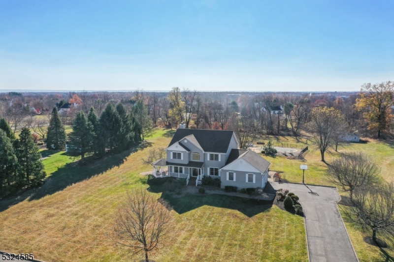 Nestled in a serene and picturesque setting in Hedgerow Estates, this stunning home on 2+ acres offers breathtaking mountain views and a swimming pool that creates a sense of tranquility and escape. Just 54 miles west of NYC.  With public sewer!  As you step inside, you'll be greeted by an open and airy floor plan that seamlessly blends indoor and outdoor living spaces. Expansive windows throughout the home frame the majestic scenery, providing a constant connection to the natural beauty that surrounds you. The spacious living area features high ceilings, hardwood flooring and abundant natural light, making it the perfect spot to relax and soak in the panoramic views. The gourmet kitchen is a chef's dream, complete with stainless steel appliances and granite counters, perfect for entertaining. Enjoy your morning coffee or evening wine on the patio or by the pool, where the views will leave you in awe. The luxurious master suite is a true retreat, having 2 walk-in closets and offering a private sanctuary. Additional bedrooms are generously sized and provide comfort and privacy. Finished walkout lower level with media room, office and kitchenette.  The beautifully landscaped yard and outdoor living spaces are ideal for hosting gatherings or simply enjoying the peace and quiet. New roof and AC.  Experience the ultimate in tranquil living with easy access to outdoor activities, yet conveniently located close to shopping, dining, train to NYC and top-rated schools.