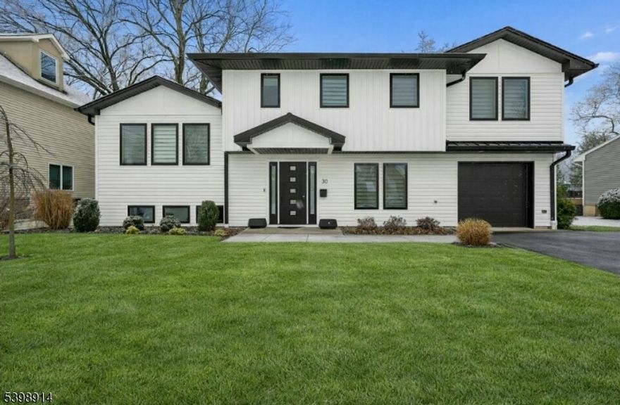 Location, location, location! Welcome to this bright, fully updated multi-level home in the desirable Woodside section featuring gleaming hardwood floors throughout, natural light, and a modern design. The spacious main living area is filled with sunlight from oversized windows and sliding glass doors that open to the backyard, blending indoor and outdoor living seamlessly. The show-stopping designer kitchen is complete with a massive center island, striking geometric tile backsplash, quartz countertops, two-tone cabinetry, and modern pendant lighting, ideal for home chefs and entertainers alike. A finished lower level adds flexible living space, perfect for recreation, guests, or a home office. Thoughtfully updated and move-in ready, this home blends comfort, style, and functionality across every level.