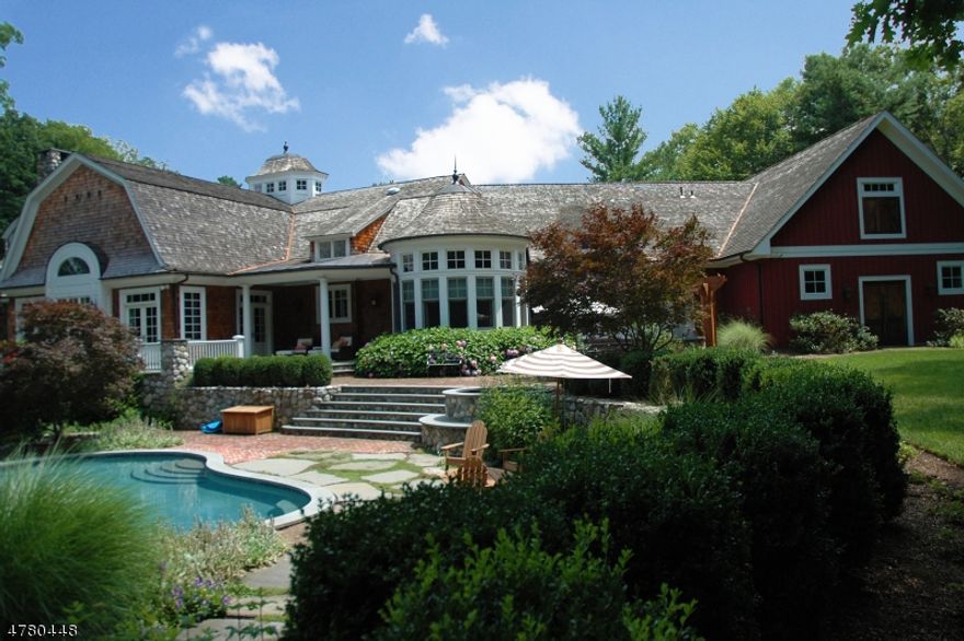 New Construction over existing foundation in 2006. Extra High ceilings and wide planked wood floors throughout. Amazing Woodwork and Moldings, all radiant heat...Enjoy the summer by the Infinity edge pool with waterfall or the hot tub! Five private acres on a cul-de-sac. Custom Kitchen imported from England and installed on site. The Primary suite has a fireplace & huge walk-in closet, and the Primary Bathroom has dual vanities, spacious shower and separate soaking tub. Double French doors lead from the bedroom to the terrace with a fireplace and stunning view of the lake. Garden level has outside access, a huge unfinished area (in-law Suite) to design as you need! Potential for subdivision, 2 horses with corral, or could be tennis or plenty of cars!