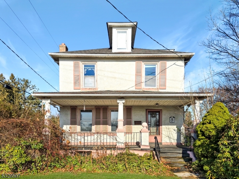 This 3-bedroom, 1 1/2-bath colonial, situated on a desirable corner lot, is brimming with character and possibilities. The home features a large front porch, ideal for relaxing with a morning coffee or greeting neighbors. A detached 2-car garage and a spacious side yard offer ample space for outdoor activities, gardening, or expansion potential. Inside, the home is ready for your vision, with plenty of room for updates and improvements. Hardwood floors lie beneath the carpets on the second floor, waiting to be uncovered and restored to their original beauty. The primary bedroom features its own private deck, a cozy spot to unwind and take in the fresh air. Additionally, a rear deck provides even more space for outdoor entertaining or peaceful retreat. Stay comfortable year-round with central air, and enjoy the charm and solid structure of this home as you transform it into your dream space. With its fantastic location, great bones, and endless potential, this property is a must-see for anyone looking to make a house their own. Don?t miss this incredible opportunity!