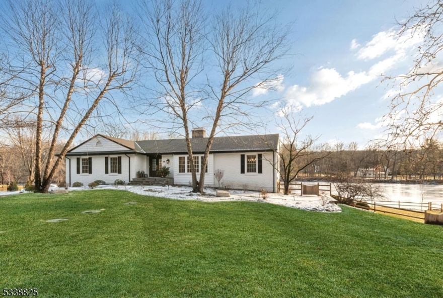 Experience luxury living in this fully renovated 3-bedroom ranch with breathtaking water views from every window. This sun-drenched home features a stunning designer kitchen with a 10-ft island, a vaulted great room with a brick-faced gas fireplace, and a sunken living room with a cozy bench seat. The walk-out lower level offers a media room, gym, and sitting room with sliders to a covered patio. Enjoy two decks, a fully fenced backyard with private pond access, and a 3-car garage. A truly spectacular retreat designed for relaxation and entertaining.