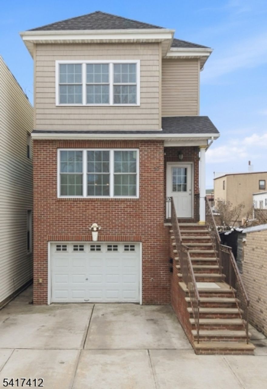 Built in 2016, this well-maintained 10 years young TWO-FAMILY home offers modern living and great income potential. The first-floor unit features open concept living space, updated kitchen with granite countertops and stainless steel appliances. Gleaming hardwood floors. 3 generously sized bedrooms, with huge WIC in primary bedroom, followed by 3 full baths, and a walkout basement for added living space. The second-floor unit offers similar features and layout with updated kitchen and hardwood flooring , 3 bedrooms and 2 full baths. Each unit provides separate laundry. Both units have separate entrances. The property also includes an oversized garage and a two-car driveway, providing plenty of parking and storage. Ideally located just one block from the Light Rail Station, making it a great option for NYC commuters! Close proximity to shopping, restaurants, dining etc.