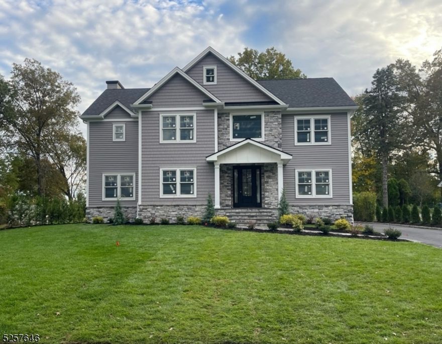 Stunning new construction home by Gjoni Construction LLC located on a dead end street and backing into the golf course. Open layout of approx. 4,800 SQFT of living space including a full finished basement with an office, full finished bathroom, bar and plenty of storage. Modern colonial design with 5 bedrooms including one on the first floor and 5.5 bathrooms. Beautiful hardwood flooring throughout the entire house, 9" foot ceilings throughout, custom trim and molding, and a spectacular kitchen with high-end appliances. The kitchen features include; a center island with quartz counter top and custom cabinetry with plenty of storage. The primary bedroom includes gorgeous vaulted ceilings, a walk-in closet, en-suite full bath with a large shower, free-standing tub, and custom tile throughout. Located in a wonderful area of Livingston within walking distance to bus stops, amazing restaurants and shops!